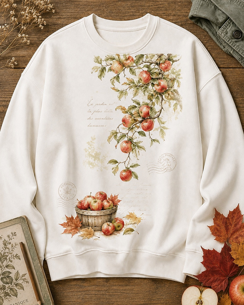 Women's white crewneck sweatshirt with apple branches and a harvest basket, front view.