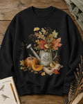 Women's black crewneck sweatshirt with an autumn bouquet in a watering can with pumpkins, front view.