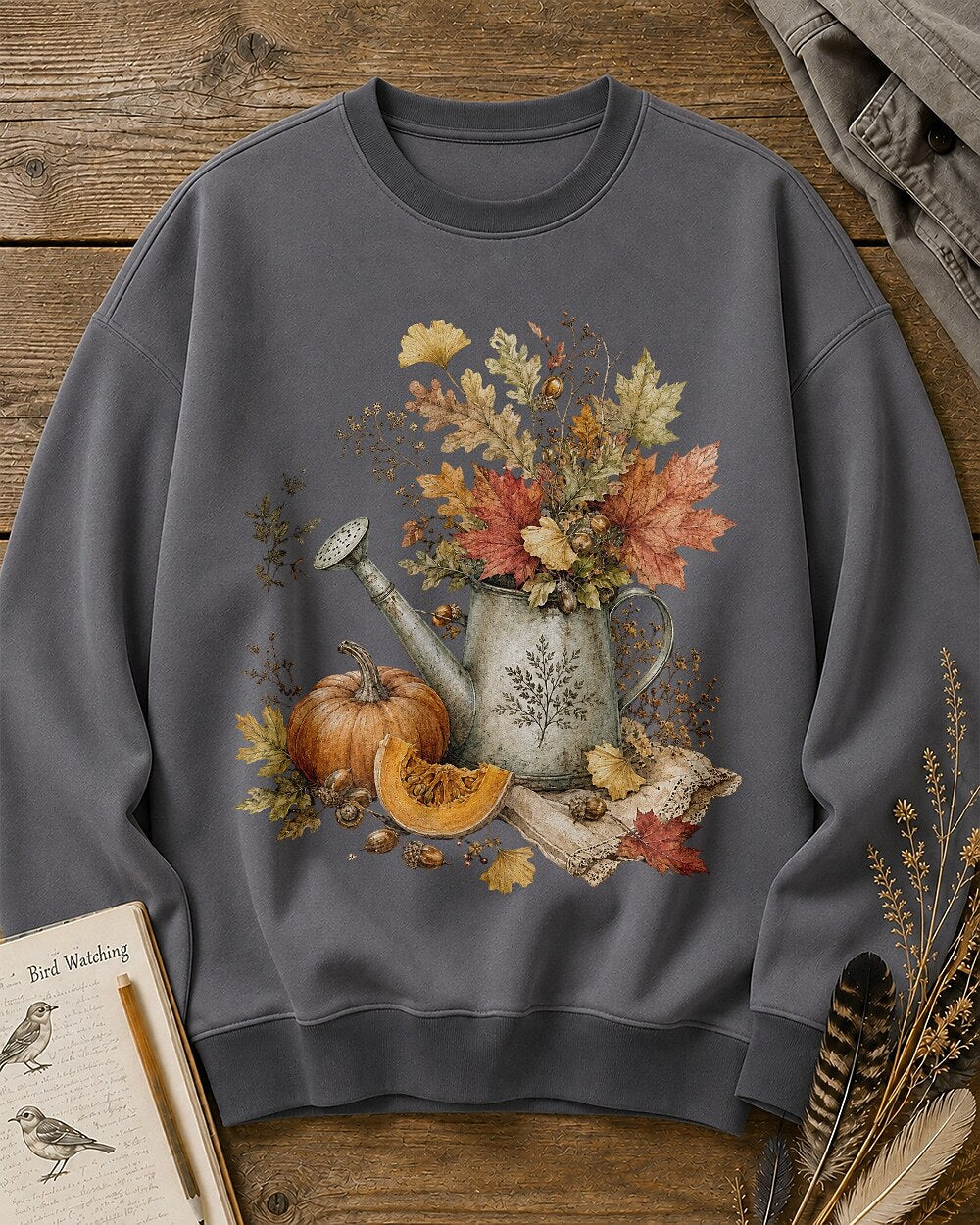 Women's gray crewneck sweatshirt with an autumn bouquet in a watering can with pumpkins, front view.