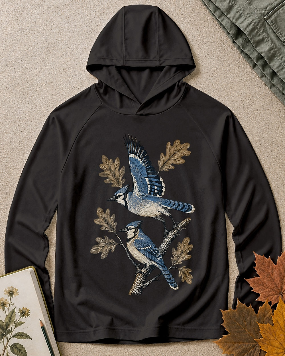 Women's black sun hoodie with blue jays perched on oak branches, front view.
