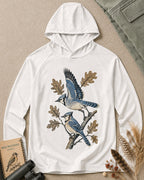 Women's white sun hoodie with blue jays perched on oak branches, front view.