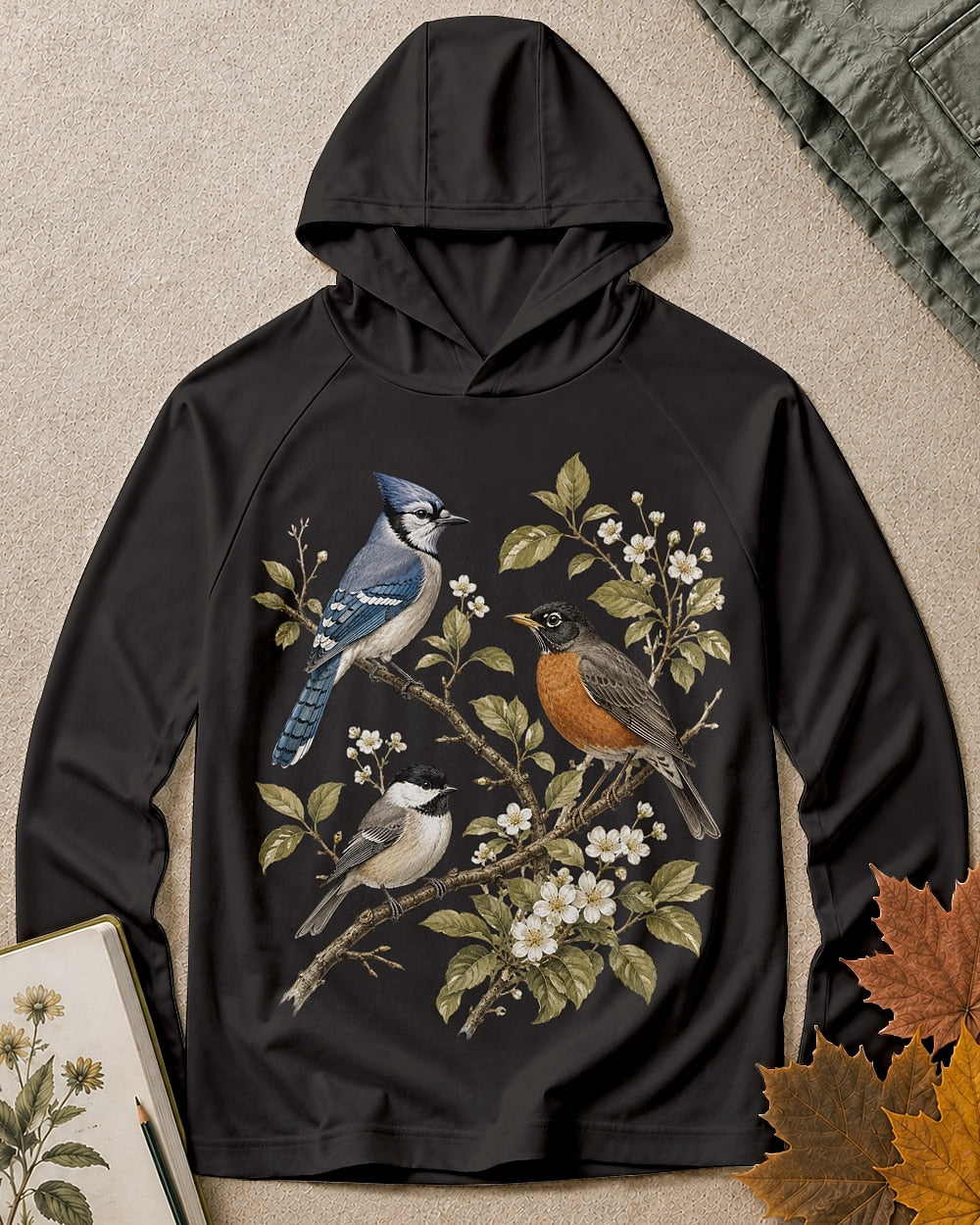 Women's black sun hoodie with a blue jay and robin on flowering branches, front view.
