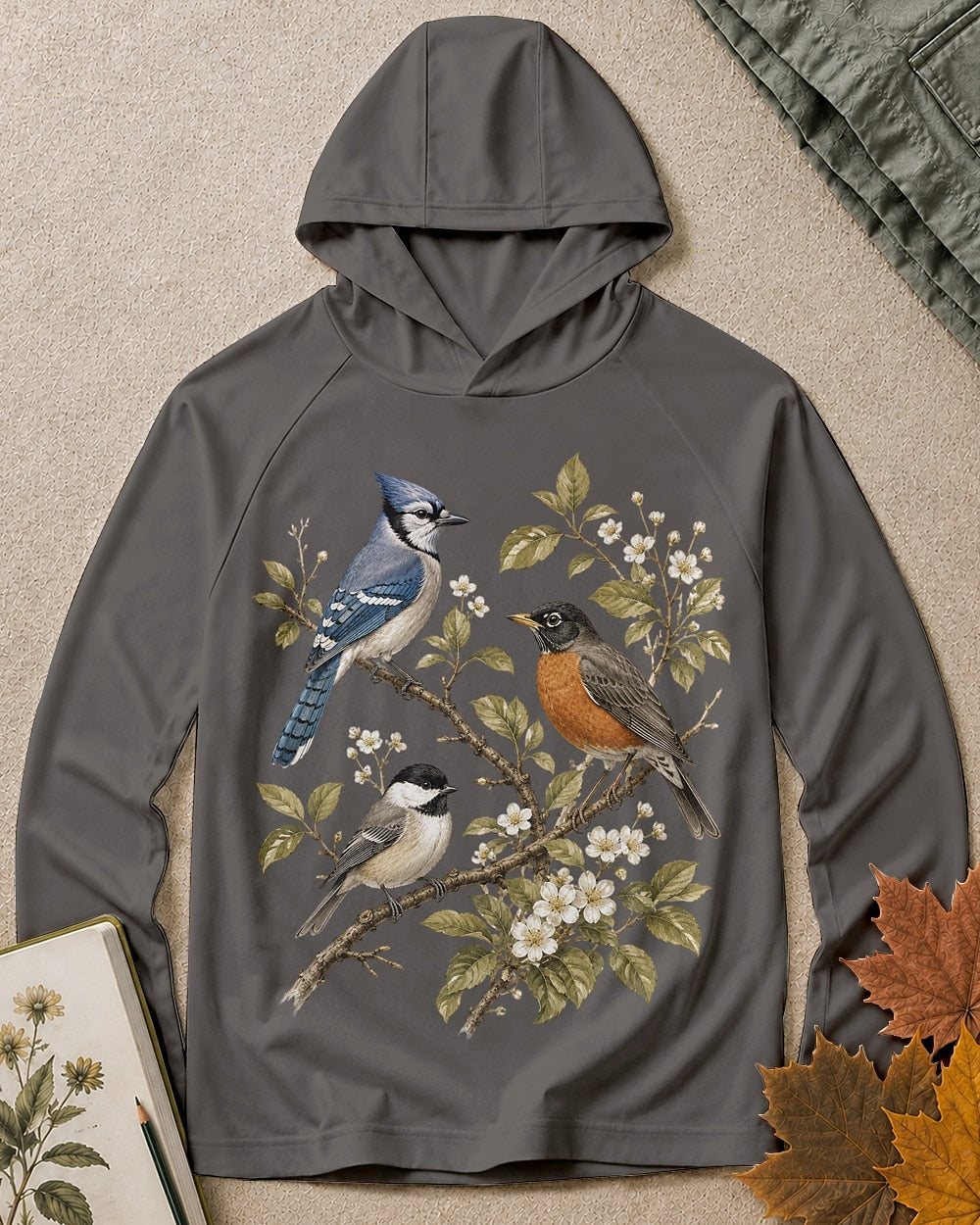 Women's dark grey sun hoodie with a blue jay and robin on flowering branches, front view.