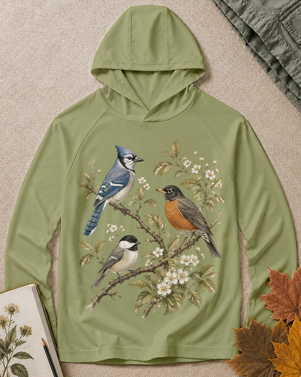 Women's green sun hoodie with a blue jay and robin on flowering branches, front view.