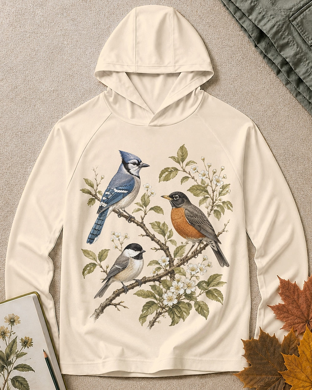 Women's light yellow sun hoodie with a blue jay and robin on flowering branches, front view.