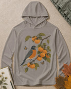 Women's gray long-sleeve sun hoodie with a bluebird and orange tree botanical print, front view.