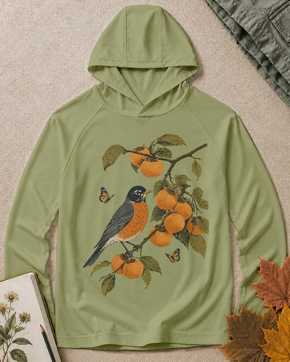 Women's green sun protection hoodie with a bluebird, oranges and leafy branches, front view.