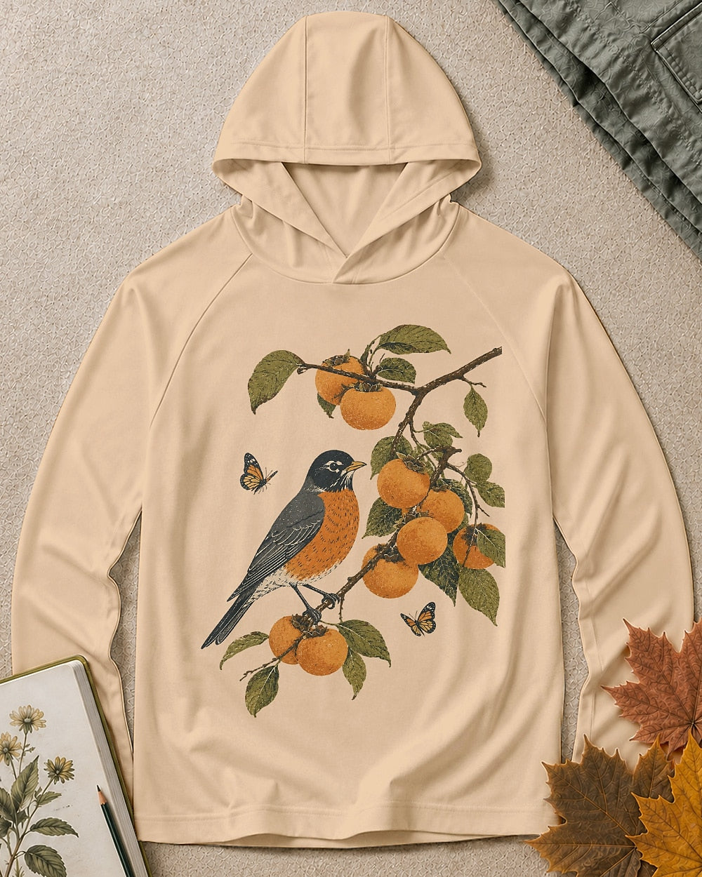 Women's light yellow sun protection hoodie with a bluebird, oranges and leafy branches, front view.