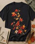 Women's black cotton T-shirt with a cardinal among orange autumn leaves, front view.