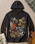 Women's black sun hoodie with cardinals, blue jays, goldfinches and flowers, front view.
