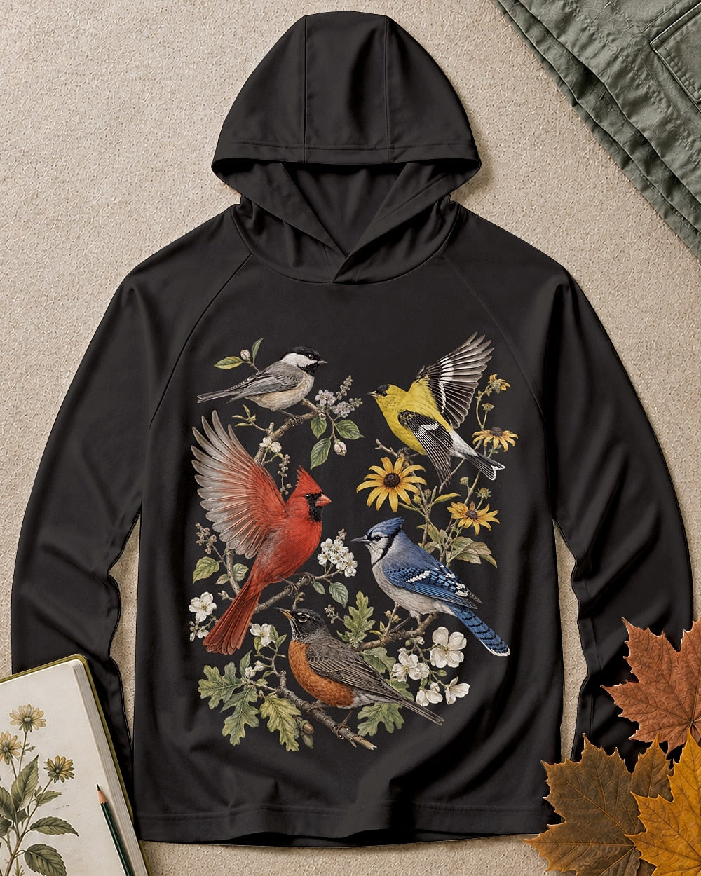 Women's black sun hoodie with cardinals, blue jays, goldfinches and flowers, front view.