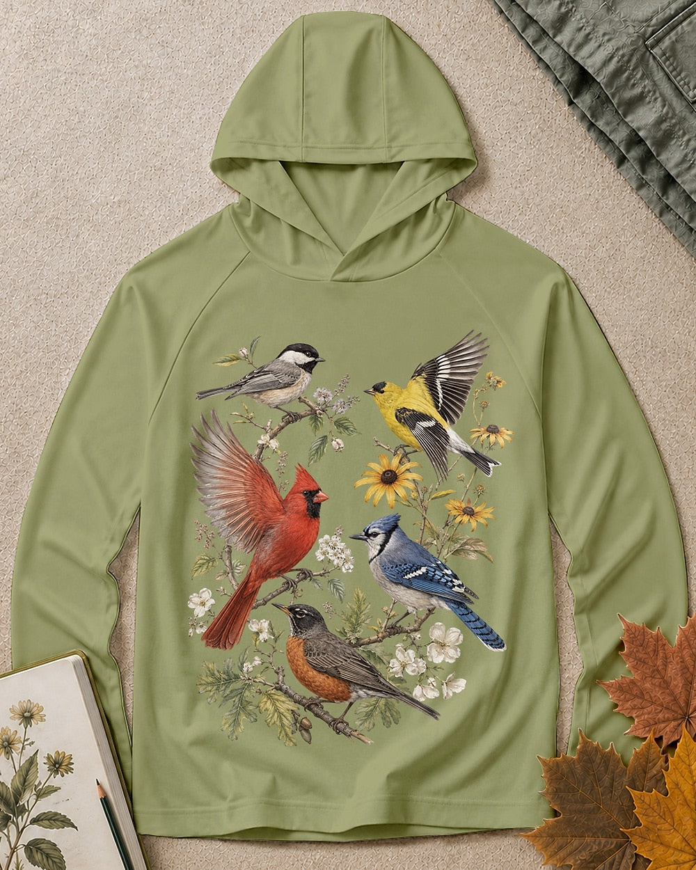 Women's green sun hoodie with cardinals, blue jays, goldfinches and flowers, front view.