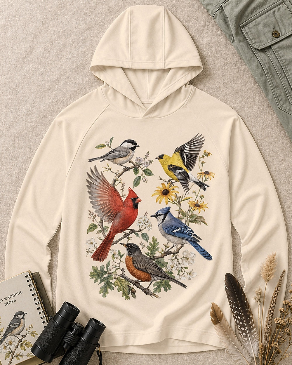 Women's light yellow sun hoodie with cardinals, blue jays, goldfinches and flowers, front view.