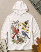 Women's white sun hoodie with cardinals, blue jays, goldfinches and flowers, front view.