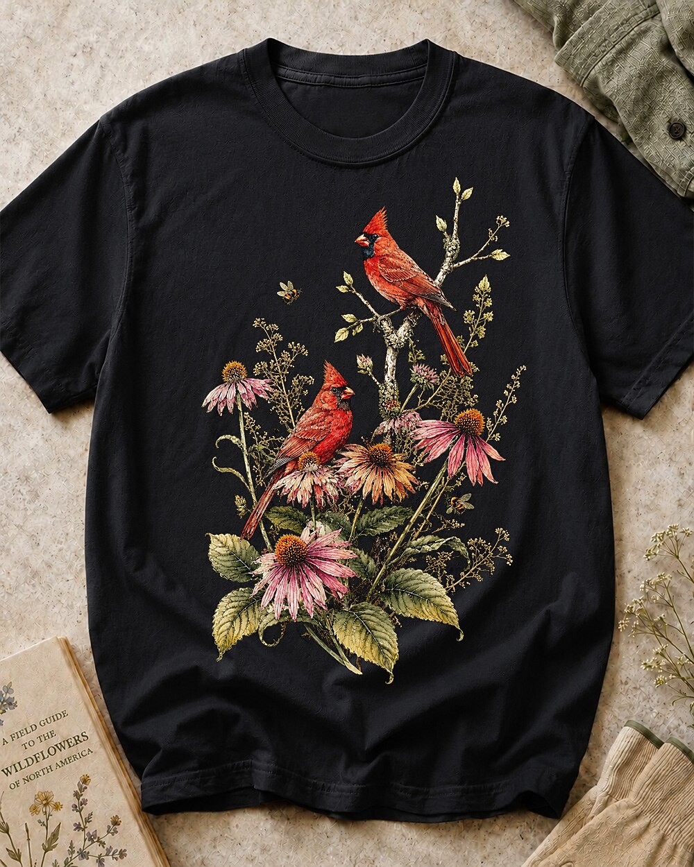 Women's black cotton T-shirt with cardinals among pink coneflowers, front view.