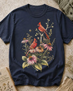 Women's dark navy cotton T-shirt with cardinals among pink coneflowers, front view.