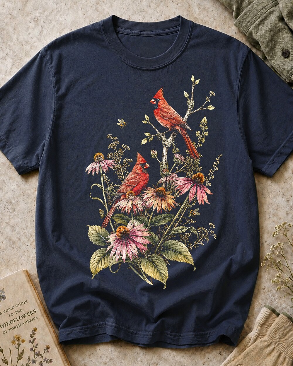 Women's dark navy cotton T-shirt with cardinals among pink coneflowers, front view.