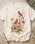 Women's off white cotton T-shirt with cardinals among pink coneflowers, front view.