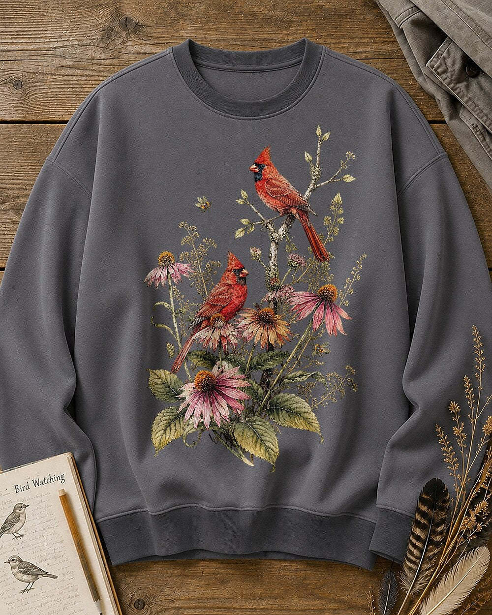 Women's gray crewneck sweatshirt with cardinals among pink coneflowers, front view.