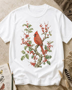 Women's white cotton T-shirt with a cardinal among red berry branches, front view.