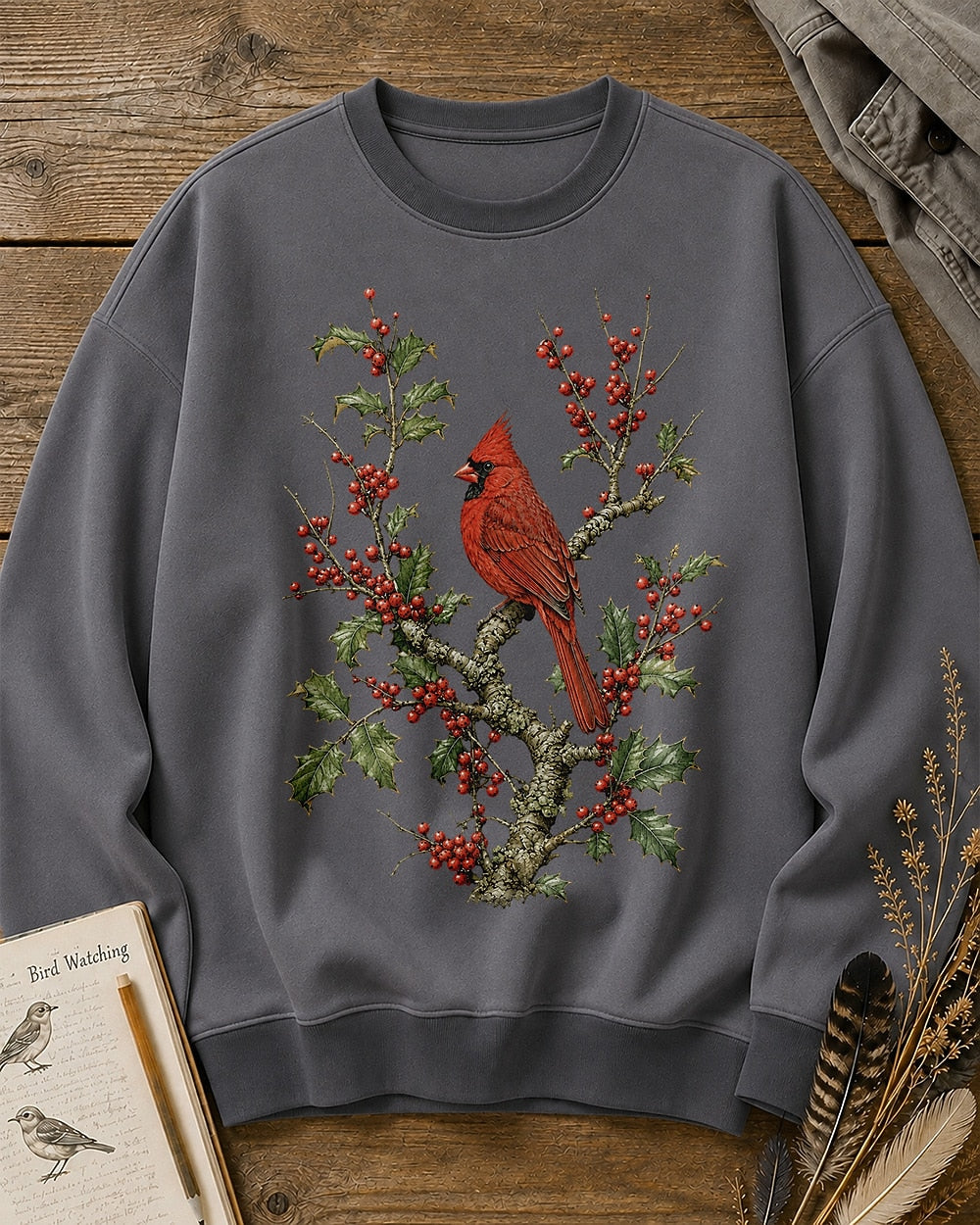 Women's gray crewneck sweatshirt with a cardinal among red berry branches, front view.