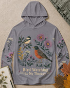 Women's gray sun hoodie with a chickadee, robin and wildflowers, front view.