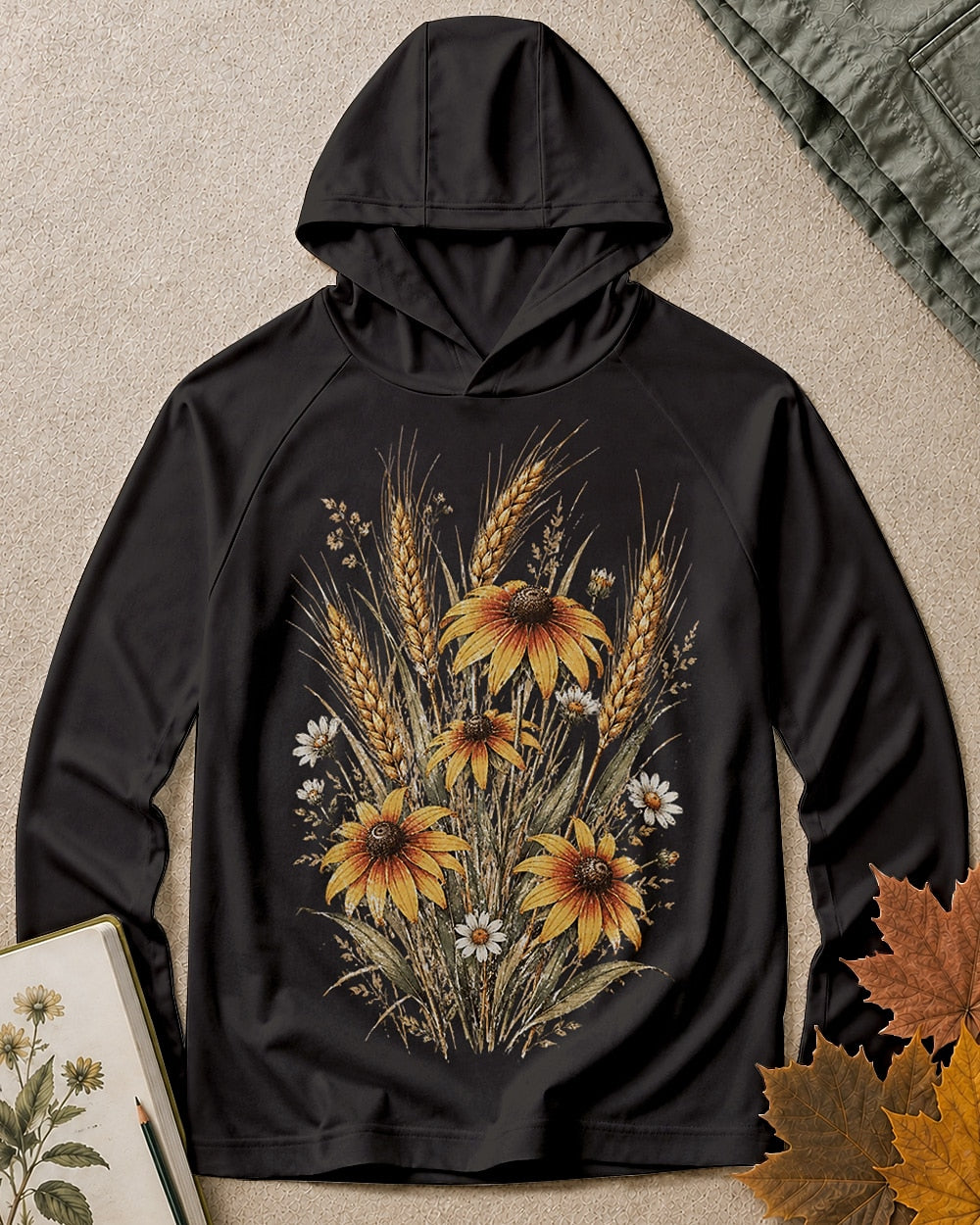 Women's black sun hoodie with a coneflower and wheat bouquet, front view.