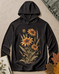Women's black sun hoodie with yellow coneflowers and wheat, front view.