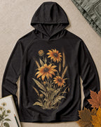 Women's black sun hoodie with yellow coneflowers and wheat, front view.
