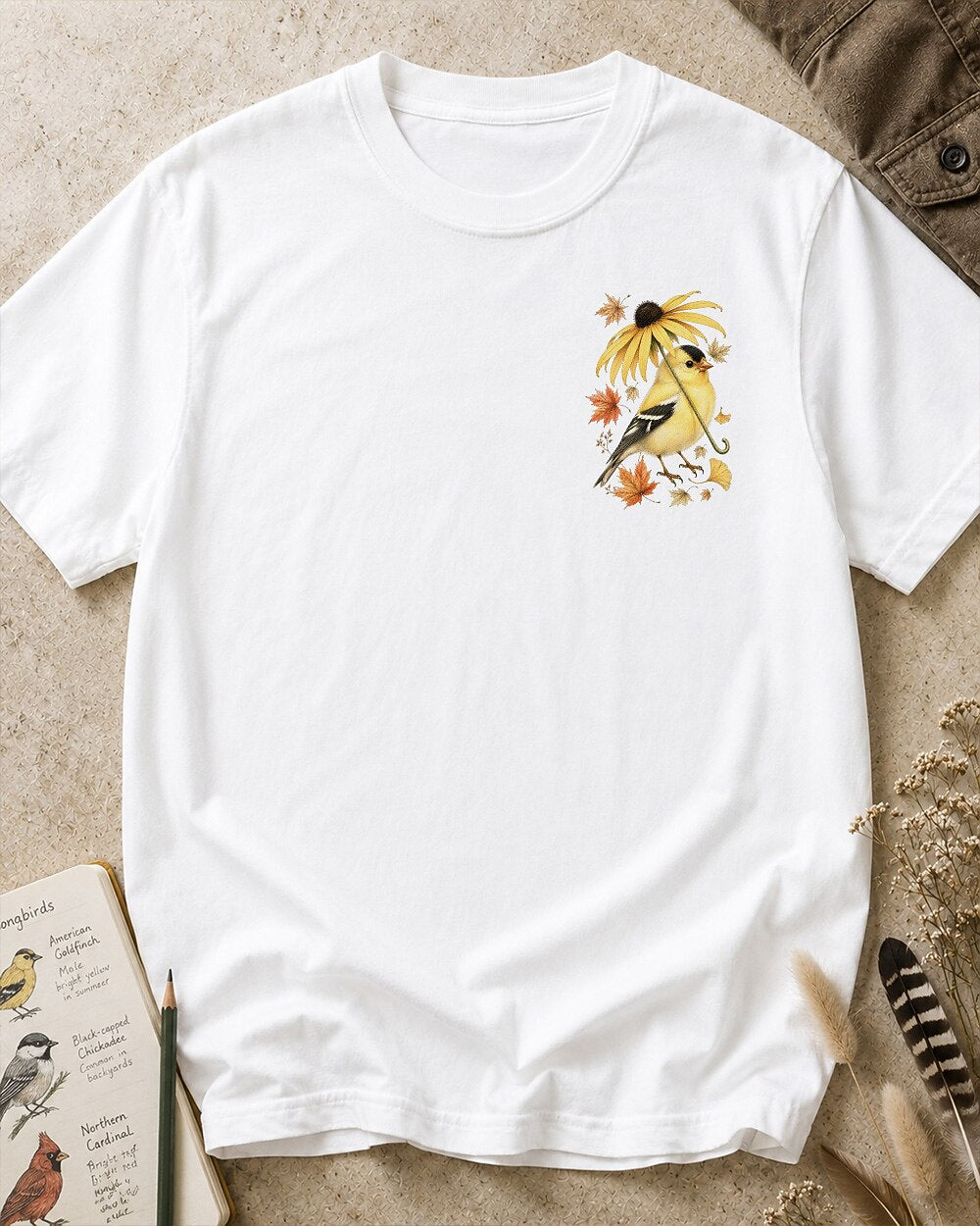 Women's white cotton T-shirt with a small goldfinch and flower chest print, front view.