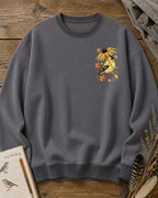 Women's gray crewneck sweatshirt with a small goldfinch and flower chest print, front view.