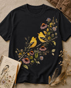 Women's black cotton T-shirt with two goldfinches among pink coneflowers, front view.