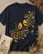 Women's dark navy cotton T-shirt with two goldfinches among pink coneflowers, front view.