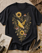 Women's black cotton T-shirt with goldfinches in flight among sunflowers, front view.