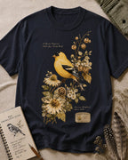 Women's dark navy cotton T-shirt with a goldfinch among yellow flowers, front view.