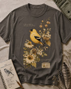 Women's gray cotton T-shirt with a goldfinch among yellow flowers, front view.
