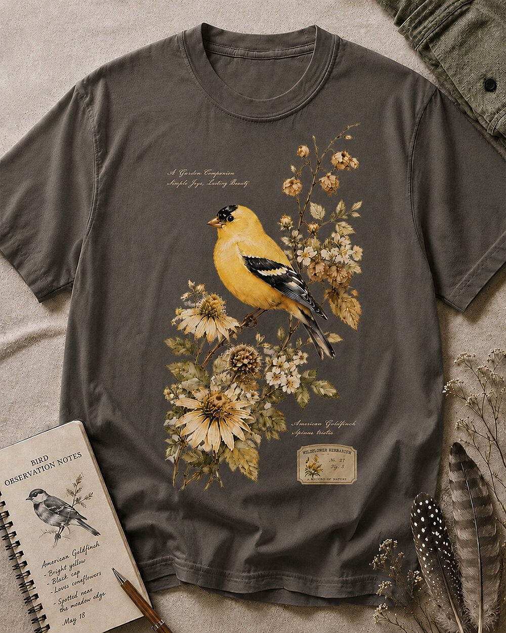 Women's gray cotton T-shirt with a goldfinch among yellow flowers, front view.