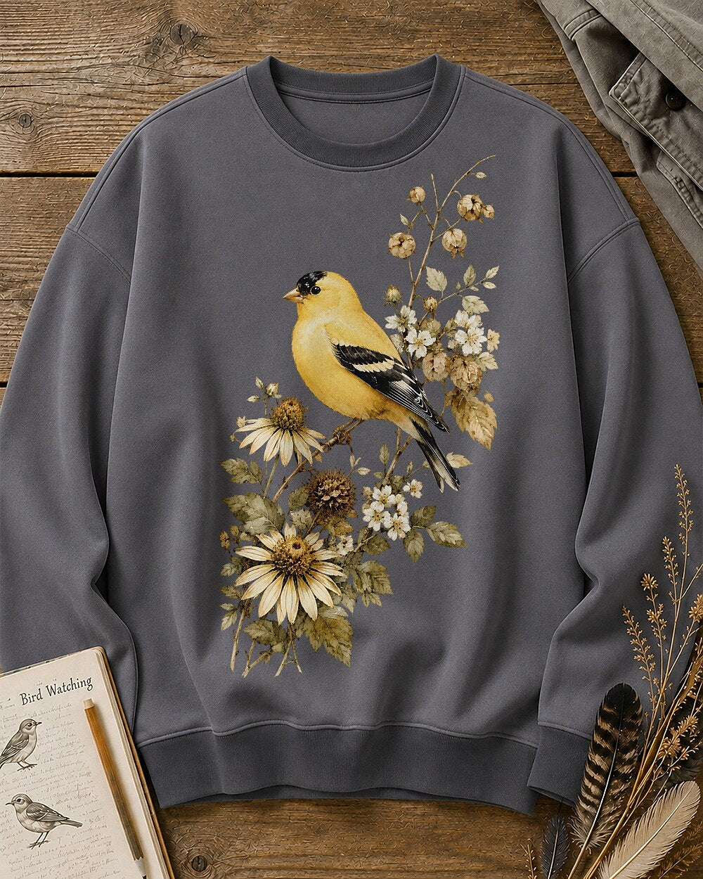 Women's gray crewneck sweatshirt with a goldfinch among yellow flowers, front view.