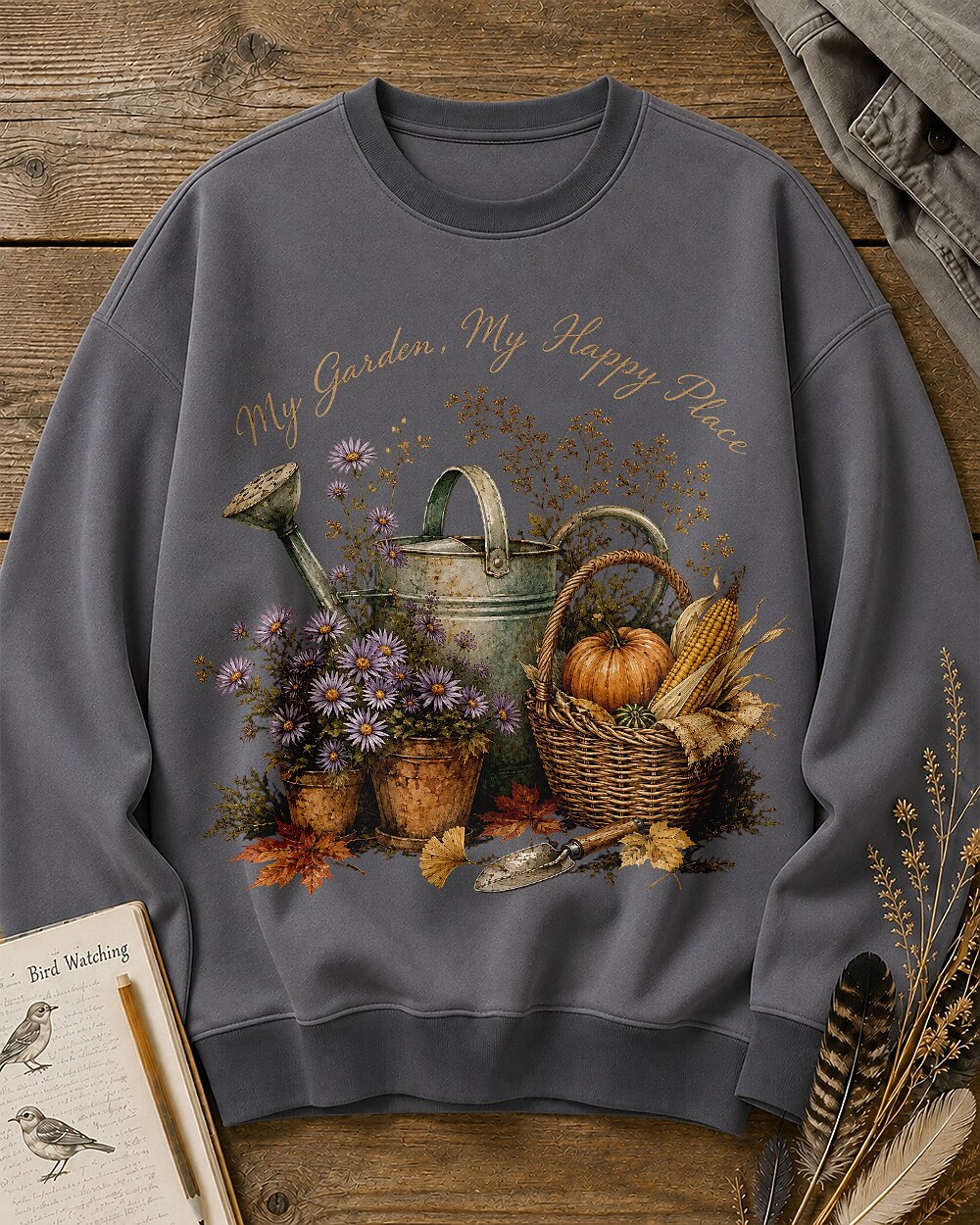 Women's gray crewneck sweatshirt with a watering can, pumpkins and harvest flowers, front view.