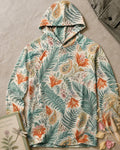 Women's blue sun hoodie with an all-over lily and paisley pattern, front view.
