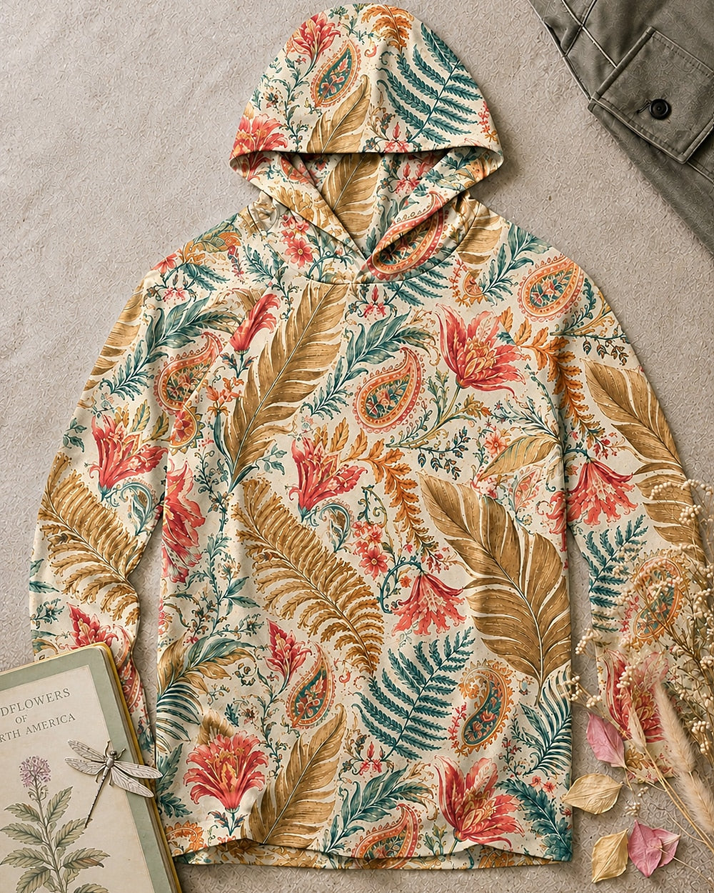 Women's green sun hoodie with an all-over lily and paisley pattern, front view.