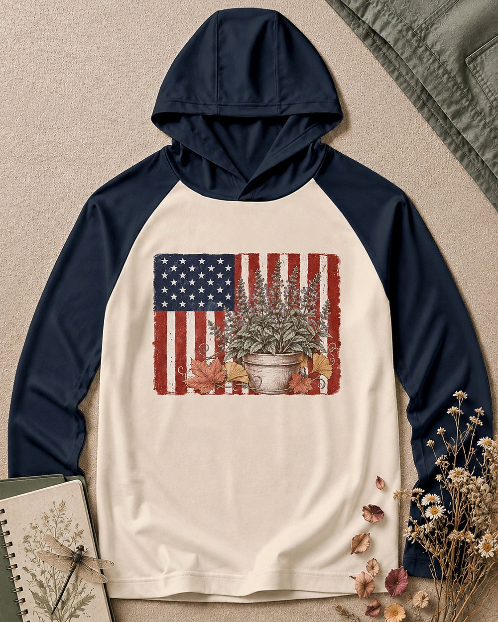 Women's navy cream sun hoodie with potted herbs and an American flag, front view.