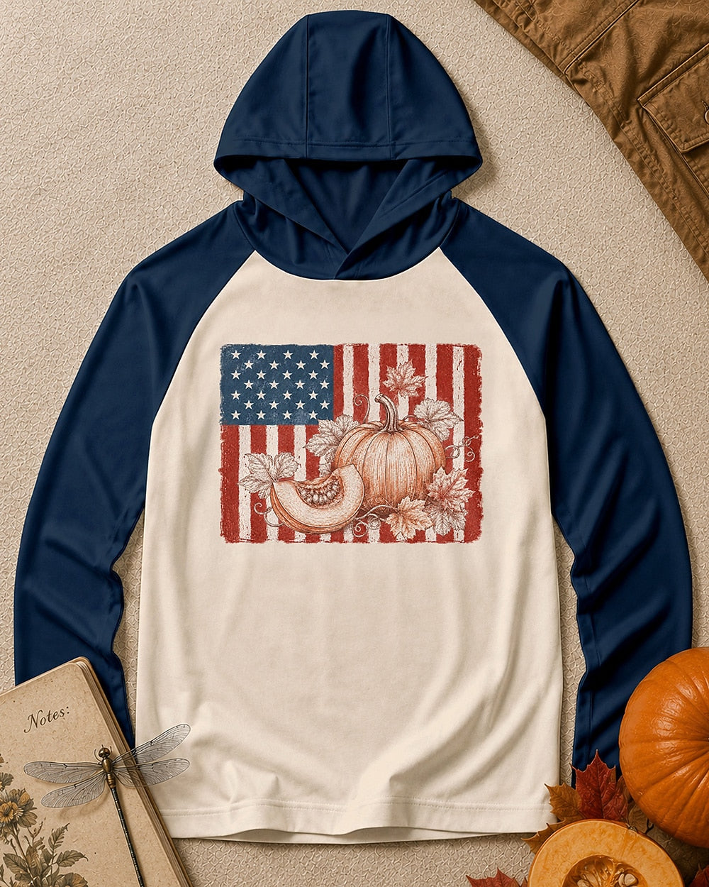 Women's navy cream sun hoodie with pumpkins and an American flag, front view.