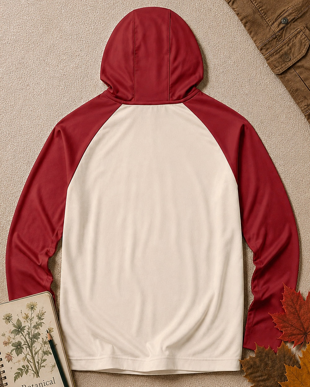 Back view of the women's sun hoodie with a plain cream body, red hood and long raglan sleeves.