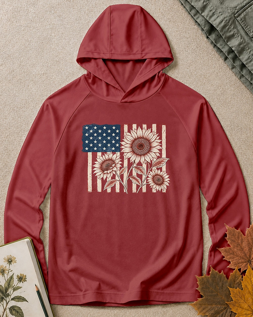 Women's burgundy sun hoodie with red sunflowers and an American flag, front view.