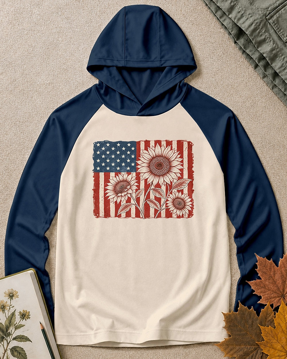 Women's navy cream sun hoodie with red sunflowers and an American flag, front view.