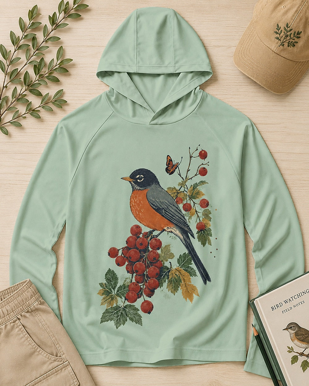 Women's green sun hoodie with a robin perched on a red berry branch, front view.
