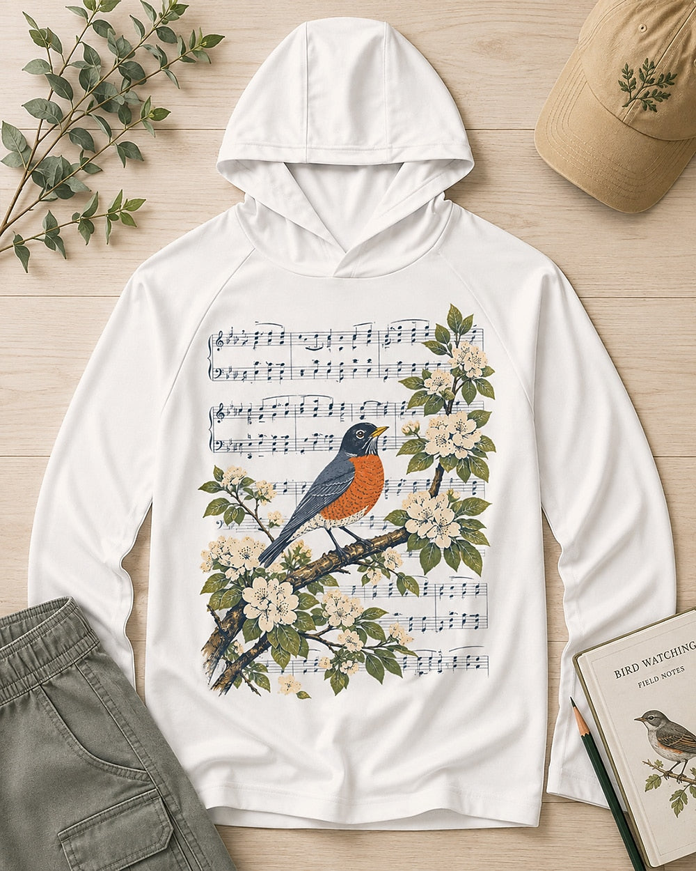 Women's white sun hoodie with a robin, blossoms and musical notes, front view.