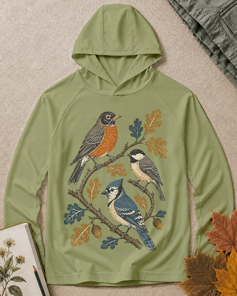 Women's green sun hoodie with a robin and blue jay among oak leaves, front view.