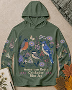 Women's green sun hoodie with robins, chickadees, blue jays and wildflowers, front view.